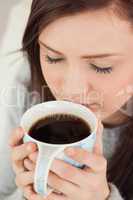 Relaxed girl drinking a cup of coffee