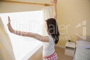 Girl stretching in a bedroom
