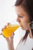 Relaxed girl drinking a glass of orange juice