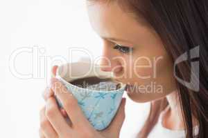 Calm girl drinking a cup of coffee