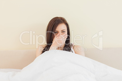 Awakened girl yawning in her bed