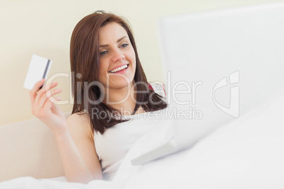 Excited girl using her laptop to shop online