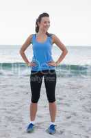 Brunette woman wearing sport wear in front of ocean