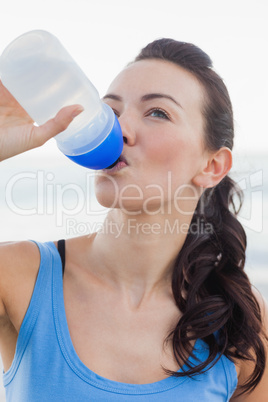 Close up view of woman drinking water after working out