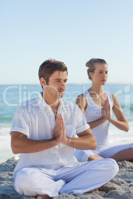 Man and woman practicing yoga