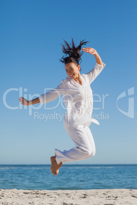 Woman jumping on the beach