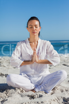 Woman practicing yoga at the beach