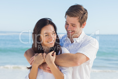 Cheerful couple relaxing on the beach during summer