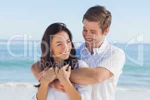 Cheerful couple relaxing on the beach during summer