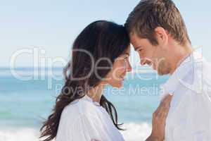 Attractive couple embracing on the beach