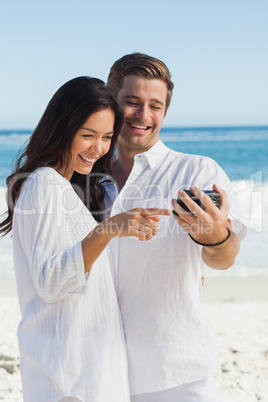 Happy couple looking at their camera