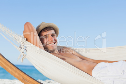 Smiling man wearing straw hat looking at camera