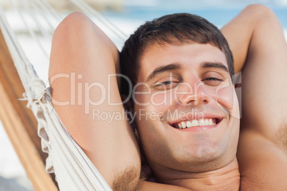 Smiling man relaxing in hammock