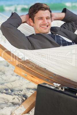 Businessman relaxing in a hammock