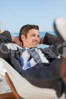 Happy businessman lying in hammock
