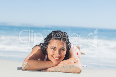 Beautiful woman lying down on the beach