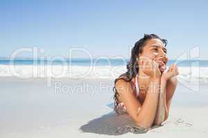 Smiling woman lying down on beach