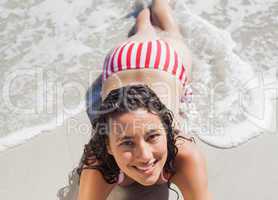 High angle view of smiling woman lying down on beach