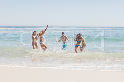 Group of friends having fun on the beach