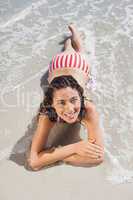 Brunette lying down on beach