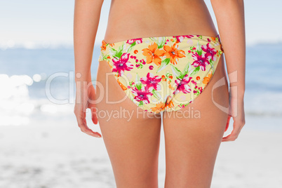 Woman in floral bikini on beach