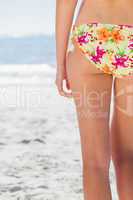 Woman in floral bikini standing back to camera