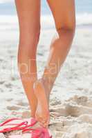 Womans legs on beach