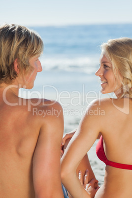 Attractive couple relaxing on the beach together
