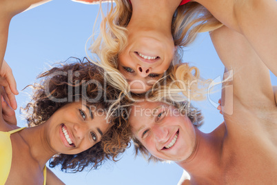 Low angle view of attractive friends on beach