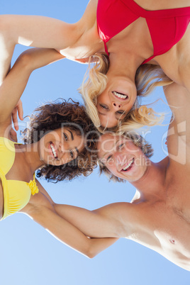 Low angle view of happy friends on beach