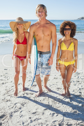 Three friends walking down on beach