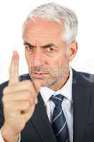 Angry businessman pointing his finger and looking at camera