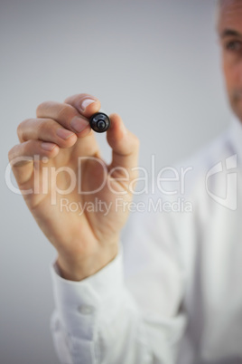 Close up of a stylish businessman holding a marker