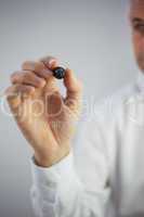 Close up of a stylish businessman holding a marker