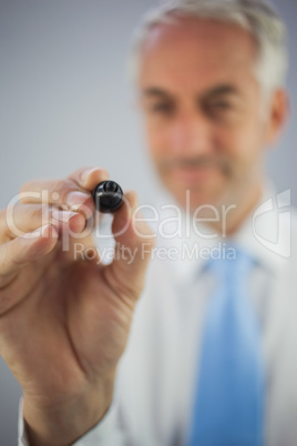 Close up of a casual businessman holding a marker