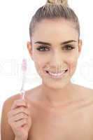 Joyful woman holding a toothbrush