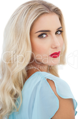 Portrait of a stylish blonde model in blue dress looking at came