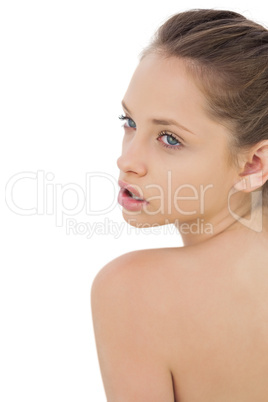 Thoughtful brunette model posing looking ober her shoulder