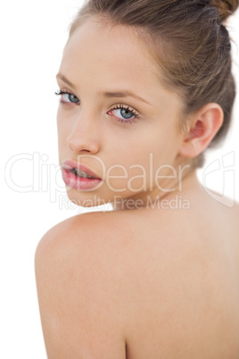 Thinking brunette model posing looking over her shoulder