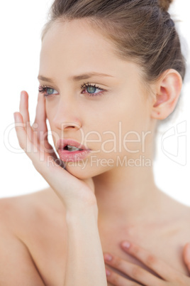 Thoughtful brunette model posing holding her head