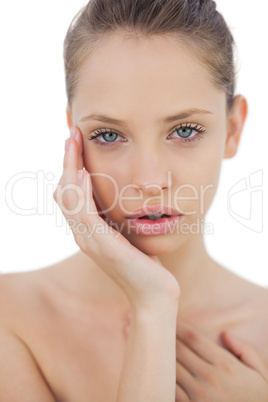 Serious brunette model posing holding her head