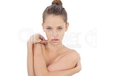 Pensive brunette model posing holding her shoulders