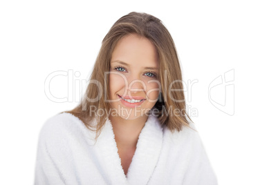 Smiling brunette in bathrobe looking at camera