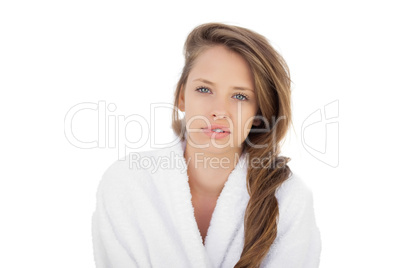 Attractive brunette in bathrobe looking at camera