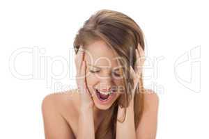 Upset brunette model holding her head and screaming