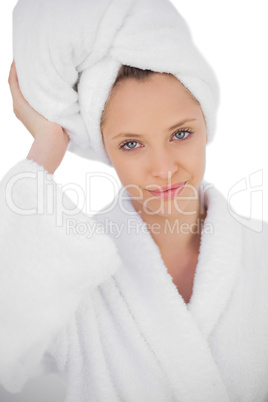 Content brunette in bathrobe looking at camera