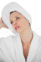 Contemplative brunette in bathrobe looking away