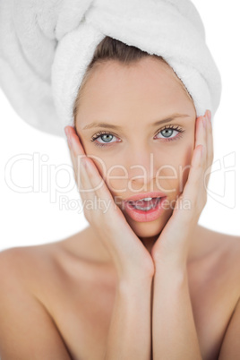 Shocked brunette drying her hair looking at camera