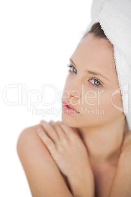 Concentrated brunette drying her hair looking at camera