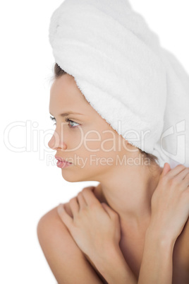 Concentrated brunette drying her hair looking away